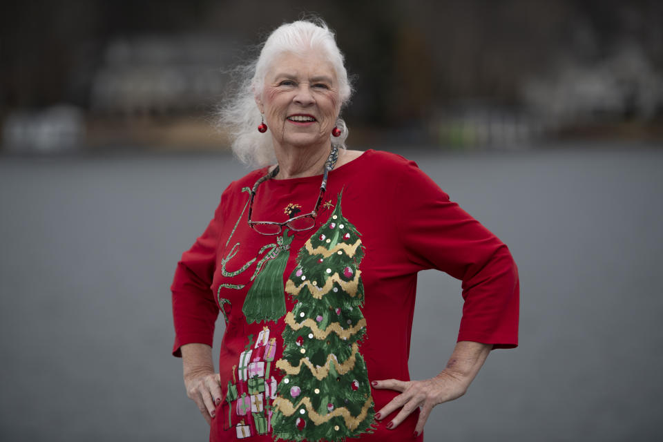 Wanda Olson poses for a photo, Friday, Dec. 17, 2021, in Villa Rica, Ga. When Olson’s son-in-law died in March after contracting COVID-19, she and her daughter had to grapple with more than just their sudden grief. They had to come up with money for a cremation. Even without a funeral, the bill came to nearly $2,000, a hefty sum that Olson initially covered. (AP Photo/Mike Stewart)