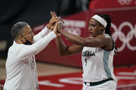 Nigeria's Aisha Mohammed (9) high five with head coach Otis Hughley Jr as she exits the game during women's basketball preliminary round game at the 2020 Summer Olympics, Monday, Aug. 2, 2021, in Saitama, Japan. (AP Photo/Charlie Neibergall)