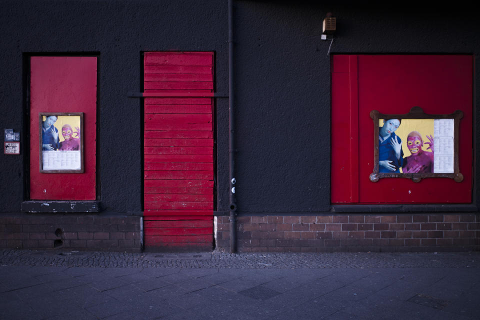 In this March 25, 2020, photo, signs are displayed near part of the front of the closed music club Wilde Renate, in Berlin, Germany. The nightclubs in the German capital have decided to keep the beat going — at least online. Berlin's nightclubs were closed on March 13 in an attempt to slow the spread of the coronavirus. In response, some clubs formed a streaming platform to let DJs, musicians and artists continue to perform. (AP Photo/Markus Schreiber)