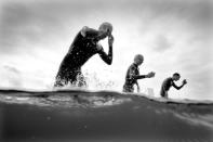 LONDON, ENGLAND - AUGUST 07: (EDITORS NOTE: Image has been converted to black and white.) Athletes finish the swimming stage during the Men's Triathlon on Day 11 of the London 2012 Olympic Games at Hyde Park on August 7, 2012 in London, England. (Photo by Adam Pretty/Getty Images)