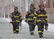 New York City firemen walk away from a massive construction crane collapse on a street in downtown Manhattan in New York February 5, 2016. REUTERS/Brendan McDermid