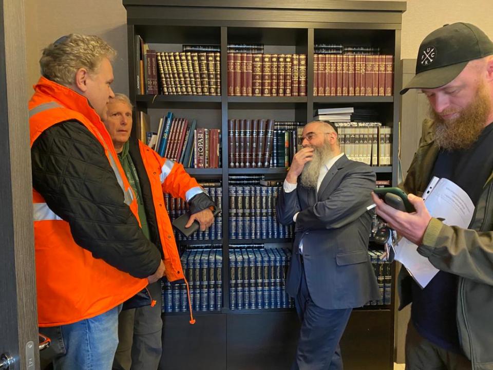 Marco Katz and Ody Norkin talk with Rabbi Avraham Wolff and Uriel Kovalenko, head of the EMTS, in Odessa, Ukraine. Kovalenko drove Norkin back to the Romanian border after Norkin delivered an ambulance to Odessa.