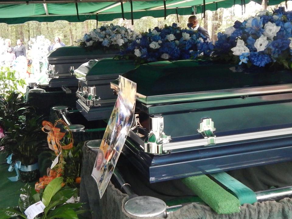 Konye, Nicoda and Marquez Melvin's caskets side by side at their funeral.