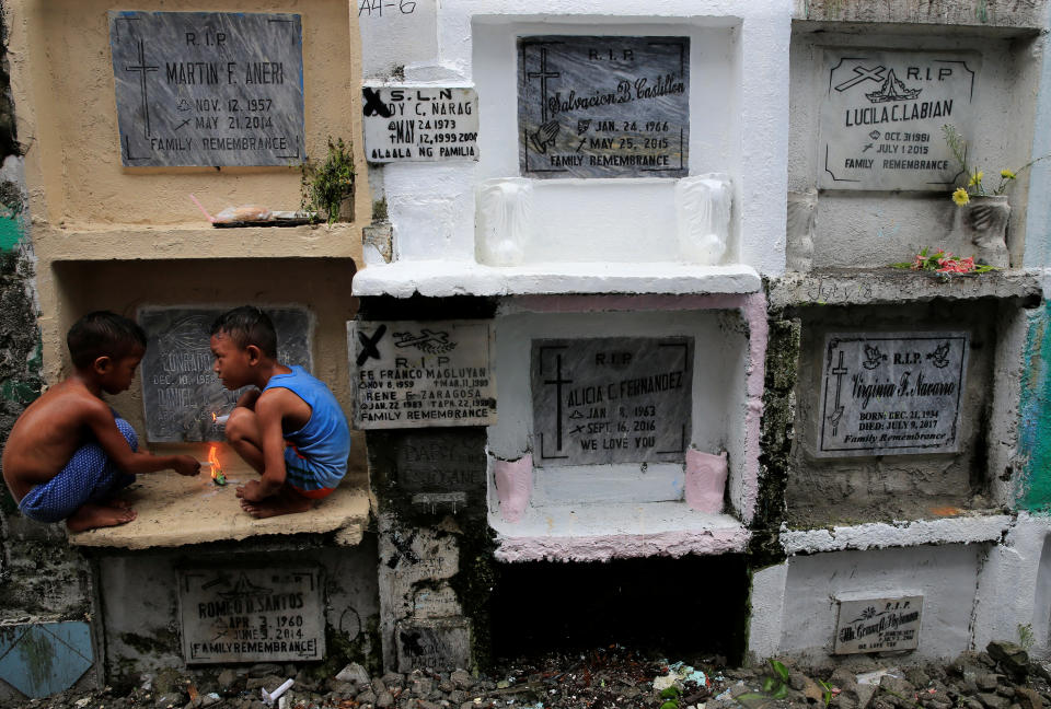 <p>Children play in front of the apartment tombs during the observance of All Saints’ Day at Navotas public cemetery in Metro Manila, Philippines, Nov. 1, 2017. (Photo: Romeo Ranoco/Reuters) </p>