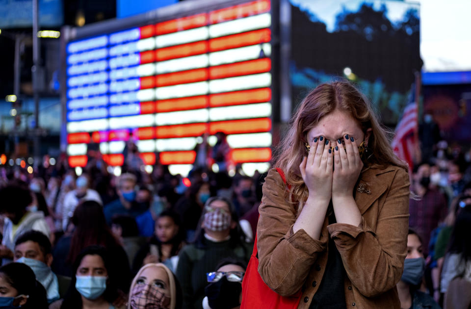 Fletcher Peters of New York, a journalism student at NYU, reacts as she watches President-elect Joe Biden on a monitor in Times Square on Saturday, Nov. 7, 2020, in New York, as he addressed the nation. (AP Photo/Craig Ruttle)