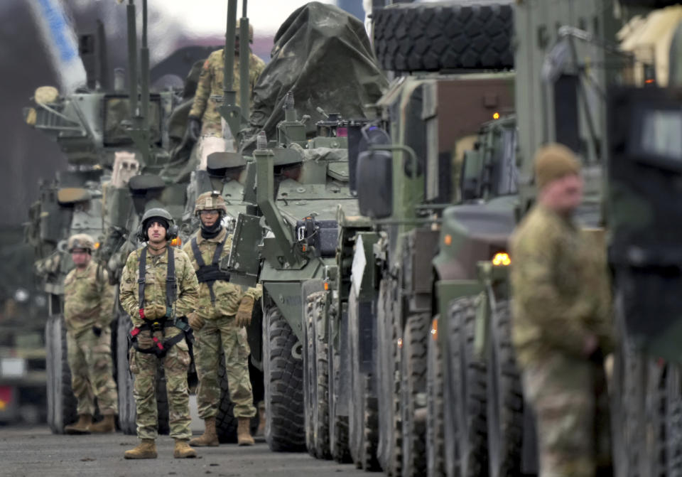 Soldiers of the 2nd Cavalry Regiment line up vehicles at the military airfield in Vilseck, Germany, Wednesday, Feb. 9, 2022 as they prepare for the regiment's movement to Romania loading of Stryker combat vehicles for their deployment to support NATO allies and demonstrate U.S. commitment to NATO Article V. The soldiers will deploy to Romania in the coming days from their post in Vilseck and will augment the more than 900 U.S. service members already in Romania. This Stryker Squadron represents a combined arms unit of lightly armored, medium-weight wheeled combat vehicles. (AP Photo/Michael Probst)