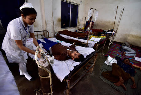 A paramedic tends to a tea plantation worker, who consumed bootleg liquor, inside a government-run hospital in Golaghat in the northeastern state of Assam, India, February 23, 2019. REUTERS/Anuwar Hazarika