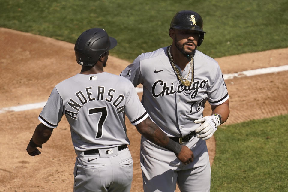 Chicago White Sox's Jose Abreu, right, celebrates after hitting a two-run home run that scored Tim Anderson (7) during the third inning of Game 1 of an American League wild-card baseball series against the Oakland Athletics, Tuesday, Sept. 29, 2020, in Oakland, Calif. (AP Photo/Eric Risberg)