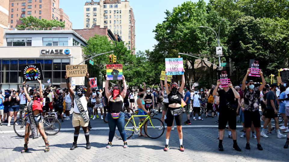 <div class="inline-image__caption"><p>People stand in a crosswalk holding "Black Lives Matter" signs while stopping traffic during at the Queer Liberation March for Black Lives & Against Police Brutality on June 28, 2020 in New York City.</p></div> <div class="inline-image__credit">Alexi Rosenfeld/Getty</div>