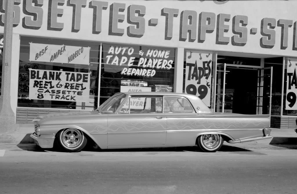 A low rider vehicle sits outside a music store selling cassettes, tapes, etc. on October 1, 1971 in Palos Verdes, California.