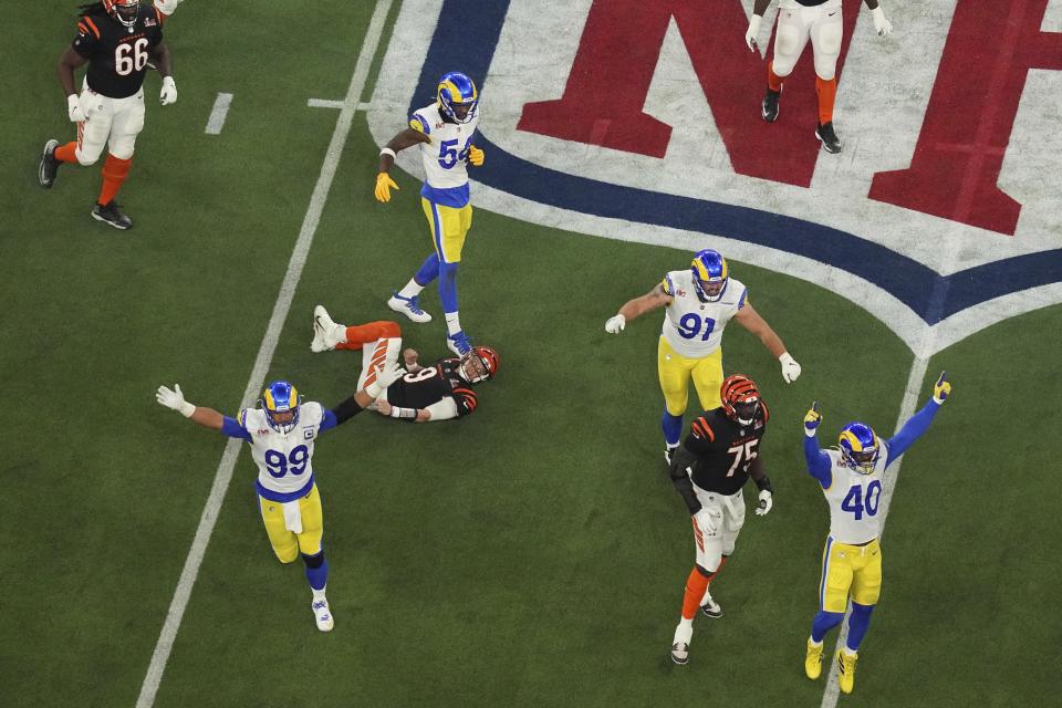 Los Angeles Rams defensive end Aaron Donald (99) celebrates after forcing Cincinnati Bengals quarterback Joe Burrow (9) to throw an incomplete pass during the second half of the NFL Super Bowl 56 football game Sunday, Feb. 13, 2022, in Inglewood, Calif. (AP Photo/Morry Gash)