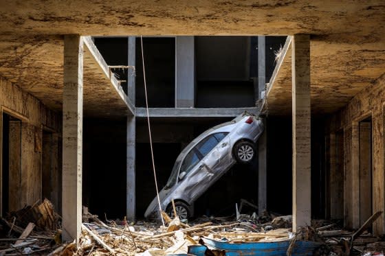 A tilted car sits above debris in Libya's eastern city of Derna on Sept. 18, 2023.<span class="copyright">Mahmud Turkia—AFP/Getty Images</span>