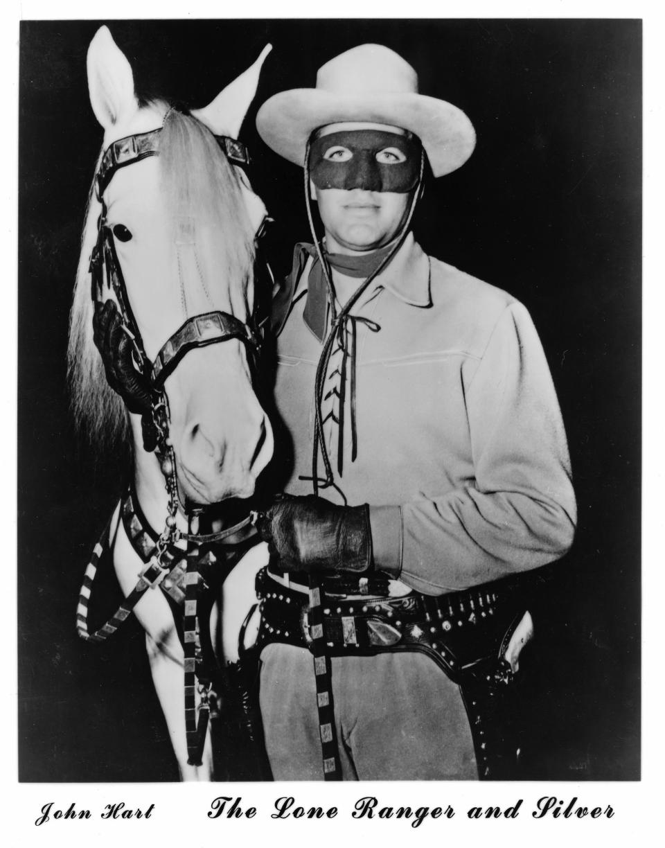 This undated publicity still, circa early 1950s, provided by the Buffalo Bill Center of the West in Cody, Wyo., shows actor John Hart, who starred in the original “The Lone Ranger” television series, which ran from 1952-1954 and horse Silver. The Colt .45 single-action revolver he used is seen holstered. The museum has acquired the pistol made famous by the masked hero of television from more than 60 years ago. The revolver is now on display at the Buffalo Bill Center of the West, in Cody. Hart used several firearms over his acting career, but this gun is special. It features ivory grips and intricate engraving. (AP Photo/Buffalo Bill Center of the West)