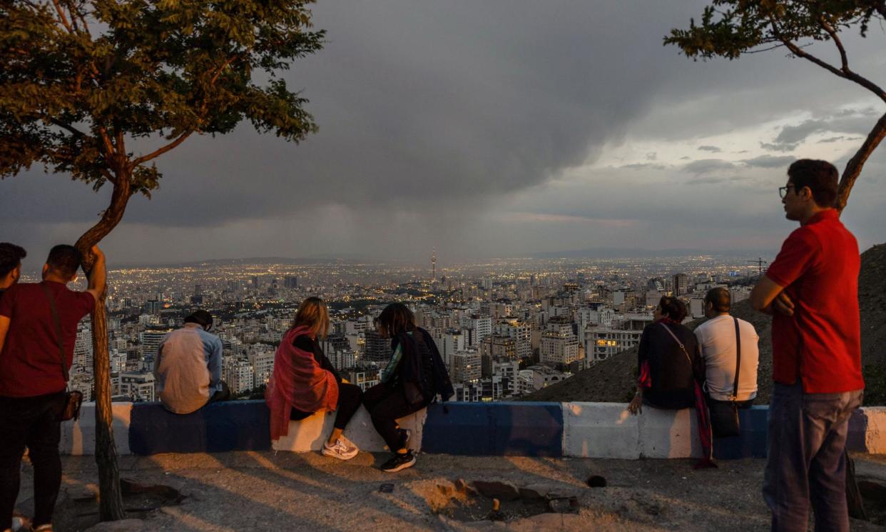 <span>Young people gather on a hilltop called the 'roof of Tehran' to watch the sunset.</span><span>Photograph: Stefanie Glinski</span>