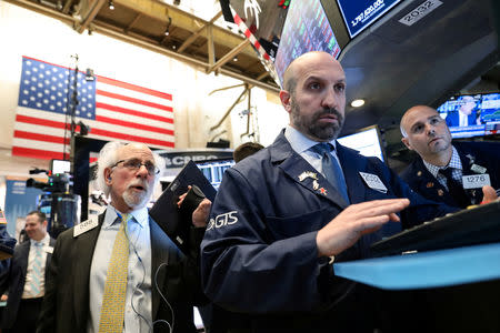 FILE PHOTO: Traders work on the floor at the New York Stock Exchange (NYSE) in New York, U.S., April 24, 2019. REUTERS/Brendan McDermid/File Photo