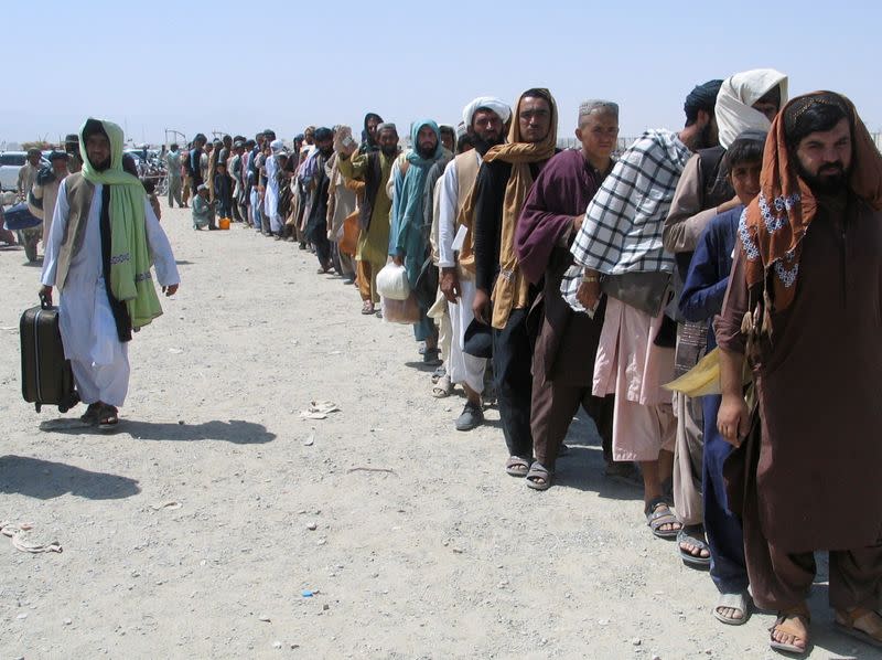 People cross Friendship Gate at Pakistan-Afghanistan border town of Chaman