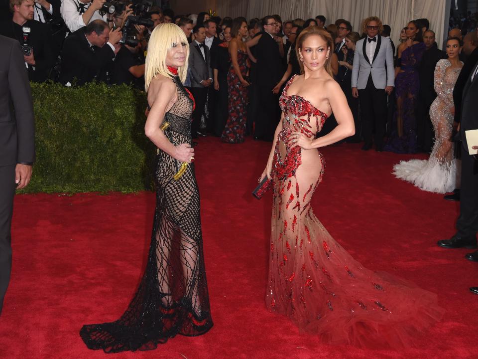 Donatella Versace and Jennifer Lopez pose on the red carpet at the 2015 Met Gala.