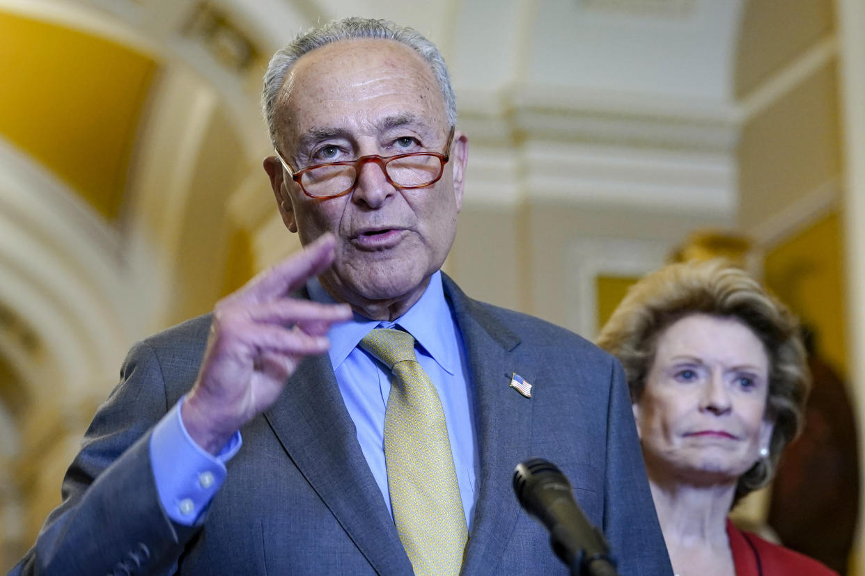 Senate Majority Leader Chuck Schumer, of D-N.Y., left, speaks as Sen. Debbie Stabenow, D-Mich., right, listens to reporters after a policy luncheon Wednesday, May 31, 2023, on Capitol Hill in Washington. (AP Photo/Mariam Zuhaib)