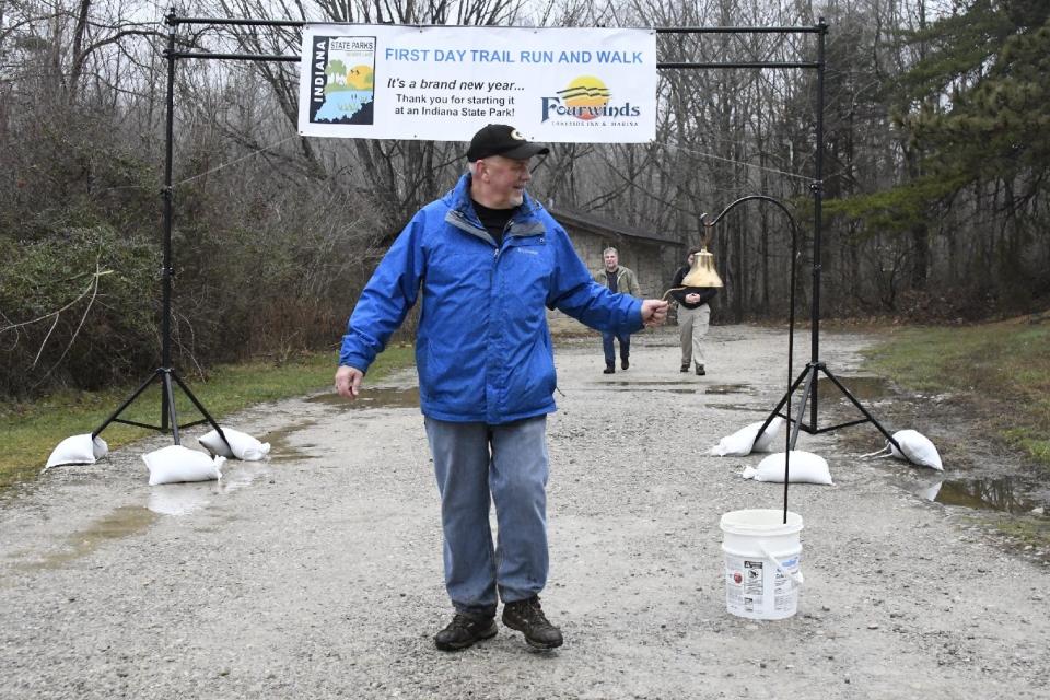 A participant rings the bell after completing the 2021 First Day Trail Run and Walk at Lake Monroe's Fairfax State Recreation Area.