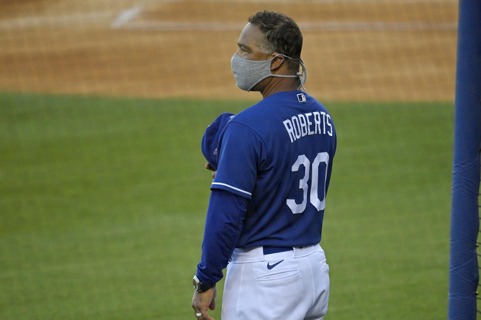 Los Angeles Dodgers manager Dave Roberts stands for the national anthem prior to an intrasquad game during baseball training Monday, July 6, 2020, in Los Angeles. (AP Photo/Mark J. Terrill)