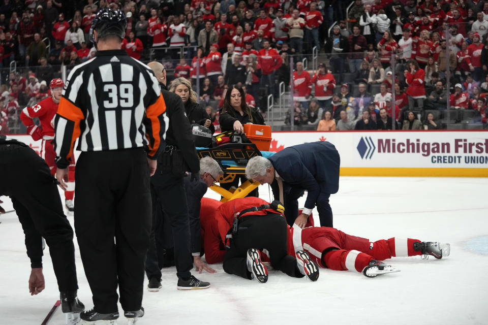 Detroit Red Wings center Dylan Larkin (71) is helped by medical staff after being hit against the Ottawa Senators in the first period of an NHL hockey game Saturday, Dec. 9, 2023, in Detroit. (AP Photo/Paul Sancya)
