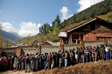 People wait in a queue to cast their votes outside a polling station during the second phase of general election in Ganderbal district in Jammu and Kashmir state April 18, 2019. REUTERS/Danish Ismail