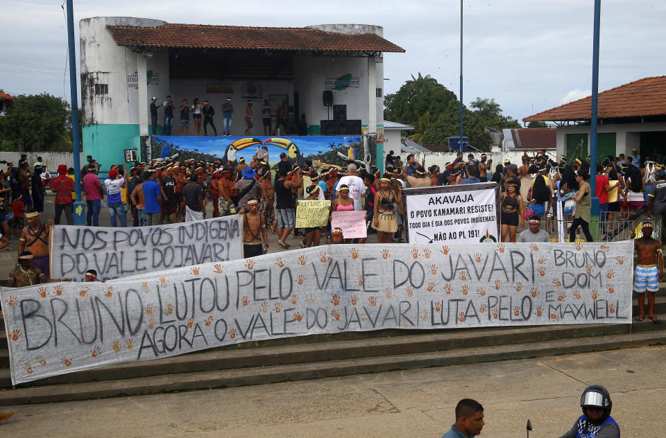 Indigenous people carry a banner with text in Portuguese that reads "Bruno fought for Vale do Javari, now Vale do Javari fights for Bruno and Dom," during a protest against the disappearance of Indigenous expert Bruno Pereira and freelance British journalist Dom Phillips, in Atalaia do Norte, Vale do Javari, Amazonas state, Brazil, Monday, June 13, 2022. Brazilian police are still searching for Pereira and Phillips, who went missing in a remote area of Brazil's Amazon a week ago. (AP Photo/Edmar Barros)