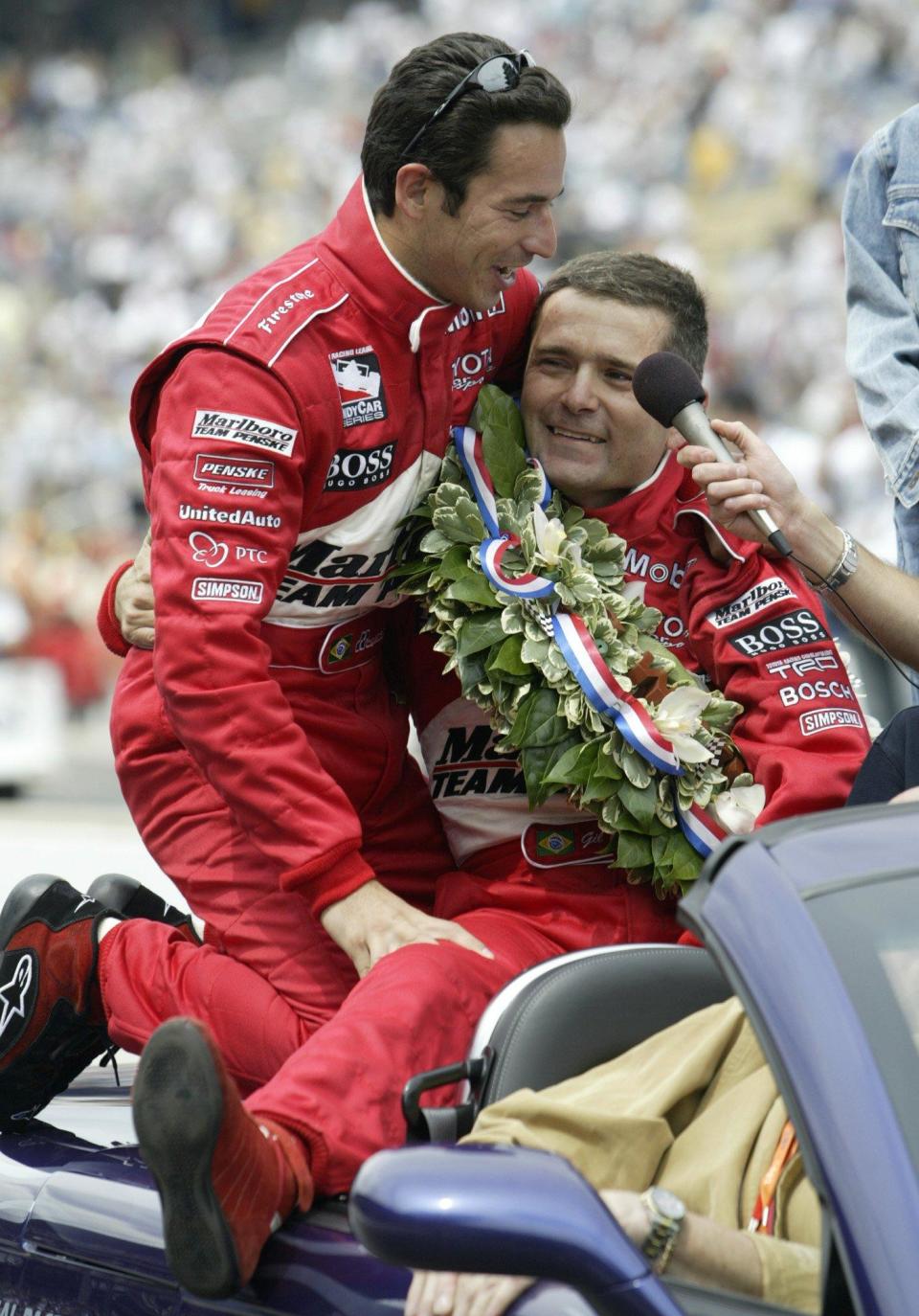 -

-Indianapolis 500 winner Gil de Ferran of Brazil, right, puts an arm around teammate and countryman Helio Castroneves as they ride in a pace vehicle following the race Sunday, May 25, 2003, in Indianapolis. Castroneves won the race the two previous years. (AP Photo/Tom Strattman)