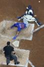 Chicago Cubs' Rafael Ortega slides safely past Milwaukee Brewers catcher Victor Caratini as he steals home during the sixth inning of a baseball game Tuesday, July 5, 2022, in Milwaukee. (AP Photo/Morry Gash)
