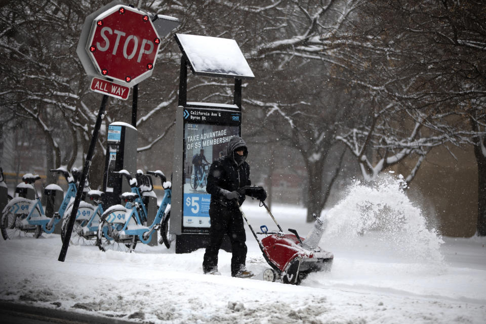 Snow is removed from the sidewalk in front of the McFetridge Sports Center Saturday, Jan. 19, 2019, in Chicago. (Erin Hooley/Chicago Tribune via AP)