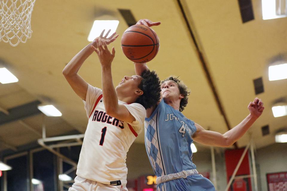 Johnston Derek Salvatore #4 blocks Rogers David Rivera in the 1st half of their game at Rogers on Tuesday, Jan. 31, 2023.