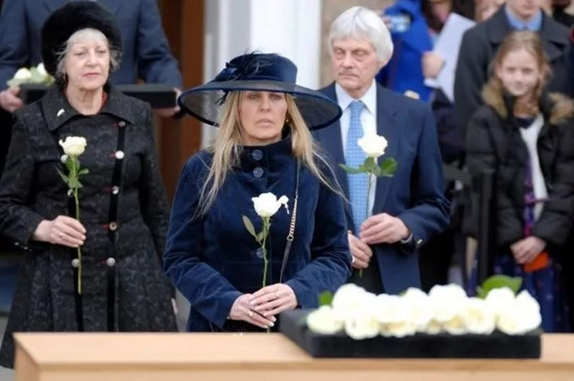 Phillipa Langley lays a rose on the coffin