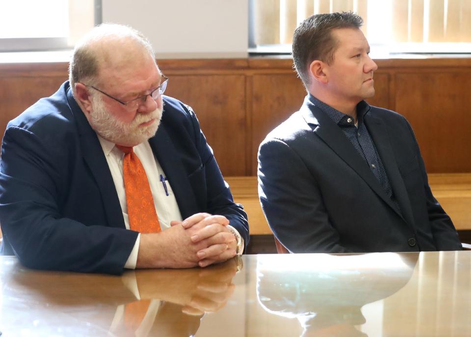 Defense attorney Mike Callahan and former state representative Bob Young listen visiting judge Edward O'Farrell delivers the verdict in Young's bench trial in Barberton Municipal Court on Thursday for assault and domestic violence. Young was acquitted of assault and found guilty of domestic violence.