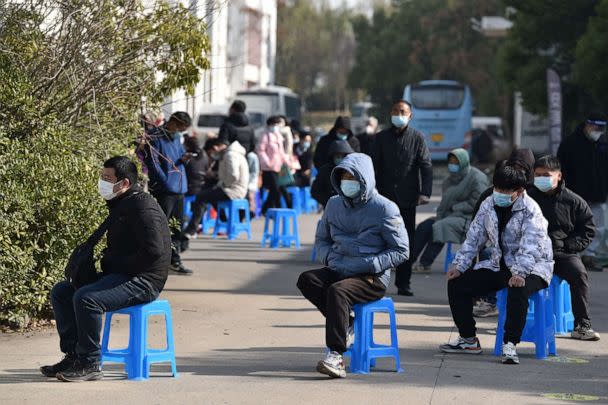 PHOTO: People queue outside a makeshift clinic transformed from a bus in Nanjing, in China's eastern Jiangsu province on Dec. 21, 2022. (AFP via Getty Images)