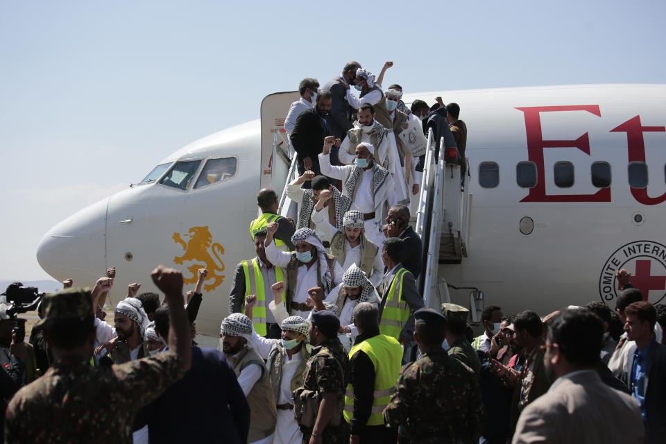 Yemeni prisoners chant slogans during their arrival after being released by the Saudi-led coalition in the airport of Sanaa, Yemen, Thursday, Oct. 15, 2020. (AP Photo/Hani Mohammed)