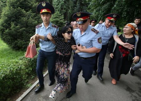 FILE PHOTO: Police officers detain an opposition supporter during a protest against presidential election results, in Almaty