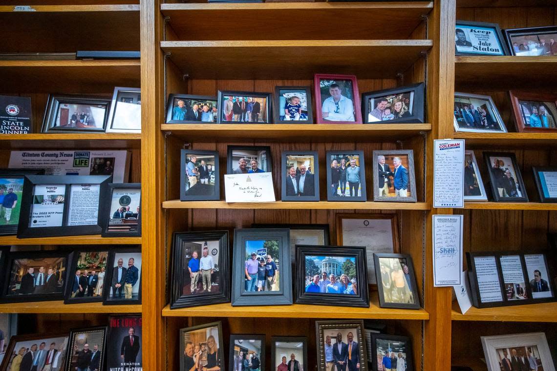 Jake Staton, Clinton County circuit clerk, has photographs of himself with Kentucky politicians on shelves in his office in Albany.