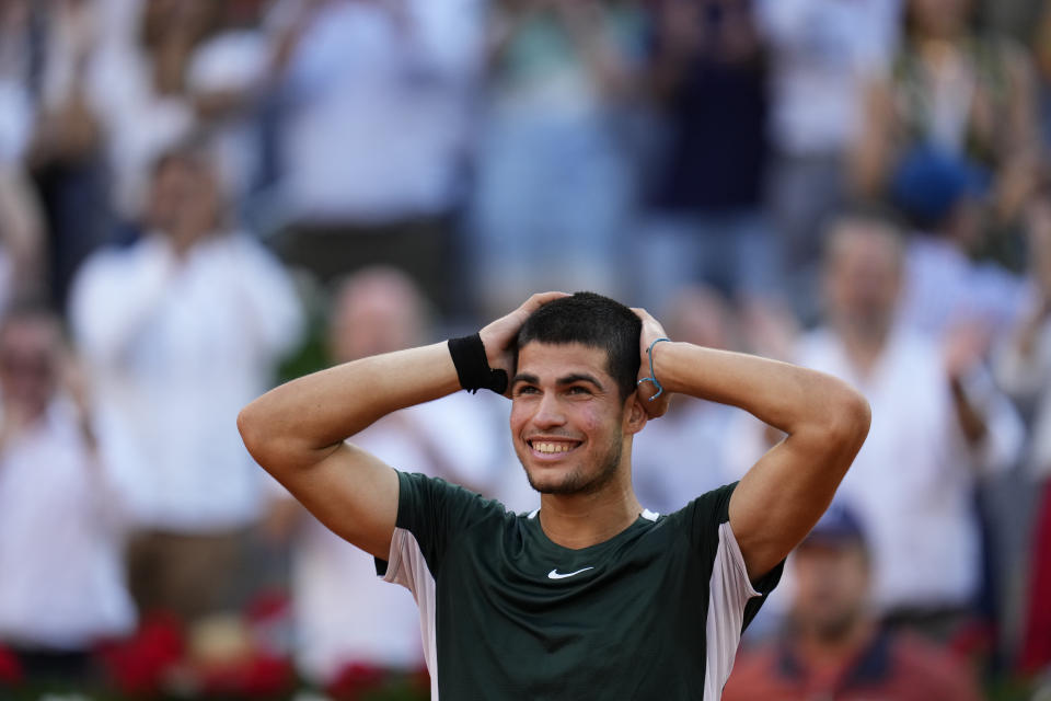 Carlos Alcaraz celebrates after defeating Novak Djokovic during a men's semifinal at the Mutua Madrid Open tennis tournament in Madrid, Spain, Saturday, May 7, 2022. (AP Photo/Manu Fernandez)