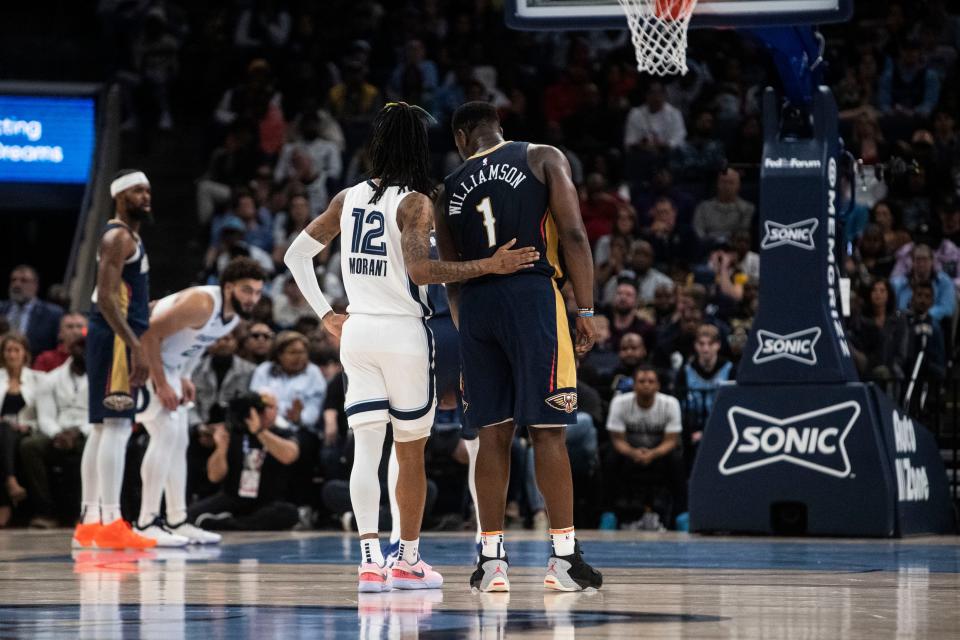 The Memphis Grizzlies guard Ja Morant (12) pats the New Orleans Pelicans forward Zion Williamson (1) on the back during a game on Dec. 31, 2022 at the Fedex Forum in Memphis.