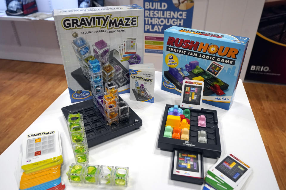 A "Gravity Maze" game, left, and "Rush Hour" game, from ThinkFun, are displayed at the 2023 Toy Fair, in New York's Javits Center, Monday, Oct. 2, 2023. While still in its early phase, a growing number of toy marketers are embracing an anacronym called MESH — Mental, Emotional and Social Health — which was first used in child development circles and by the American Camp Association. (AP Photo/Richard Drew)