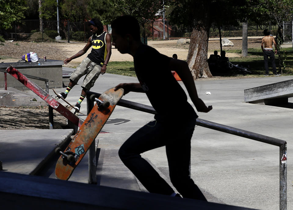 A skateboarder is silhouetted as he walks up the steps at a park on Monday, May 12, 2014, in Los Angeles. A warm weekend was expected to give way to a sweltering work week in SouthernCalifornia, with whipping winds of the sort already felt across the West bringing dry conditions and high fire danger.(AP Photo)