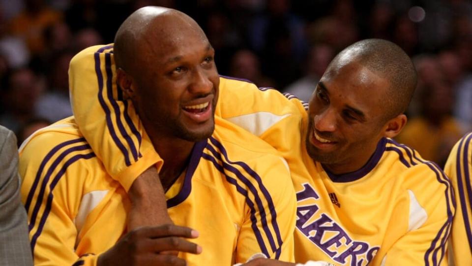 This 2008 photos shows then-Los Angeles Lakers players Lamar Odom (left) and Kobe Bryant (right) having a playful moment on the bench at The Staples Center in Los Angeles. (Photo by Stephen Dunn/Getty Images)