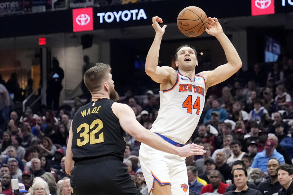 New York Knicks forward Bojan Bogdanovic (44) loses control of the ball in front of Cleveland Cavaliers forward Dean Wade (32) in the first half of an NBA basketball game, Sunday, March 3, 2024, in Cleveland. (AP Photo/Sue Ogrocki)