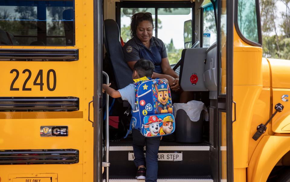 A student gets on the bus after his first day of school at San Carlos Park Elementary School on Wednesday, Aug. 10, 2022.