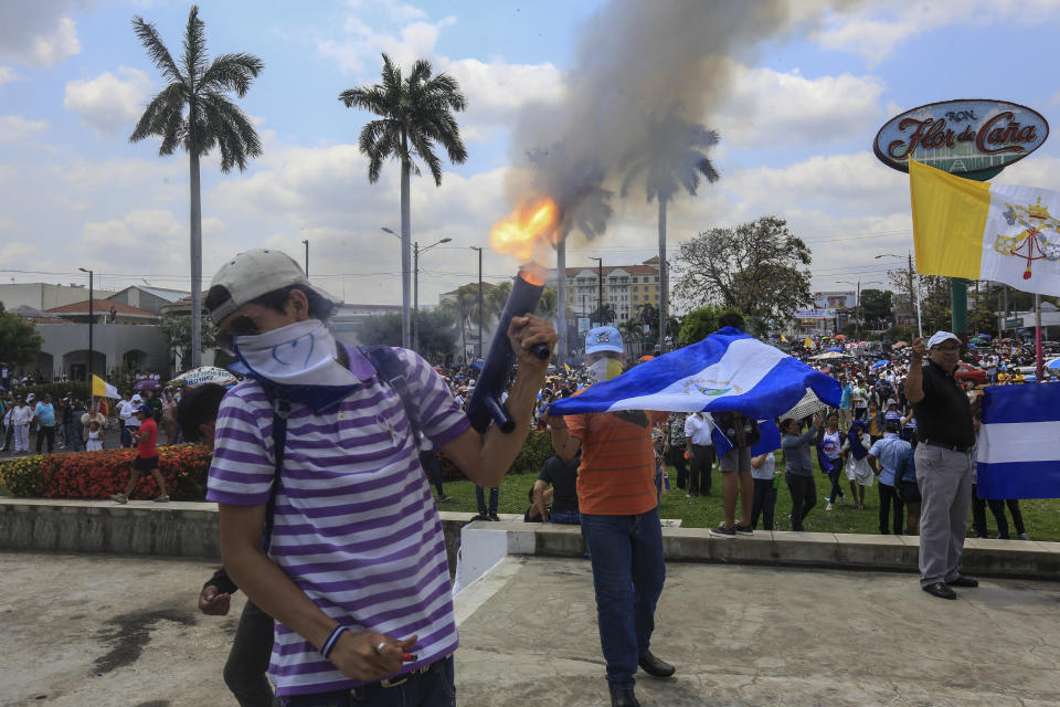 An anti-government protester fires a homemade mortar on the sidelines of a Stations of the Cross procession on Good Friday in Managua, Nicaragua, Friday, April 19, 2019. Good Friday religious processions in Nicaragua’s capital have taken a decidedly political tone as people have seized on a rare opportunity to renew protests against the government of President Daniel Ortega. (AP Photo/Alfredo Zuniga)