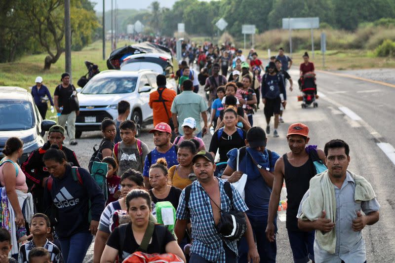 Migrants walk in a caravan to reach the U.S. border through Mexico, in Escuintla