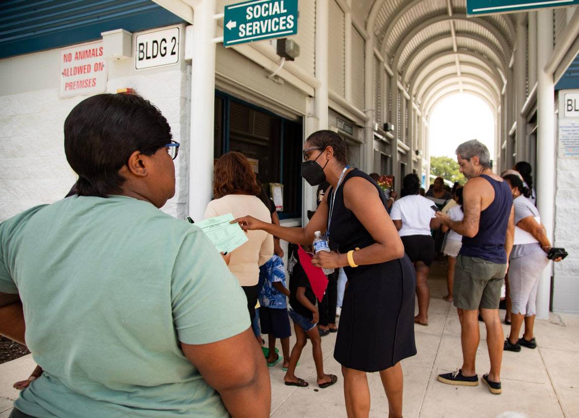 Natalie Moffitt, Broward County Family Success Administration director, speaks to a person waiting to sign up for LIHEAP, a light bill assistance program, at Annie L. Weaver Health Center in Pompano Beach, Fla., on Thursday, July 20, 2023. Lauren Witte/lwitte@miamiherald.com