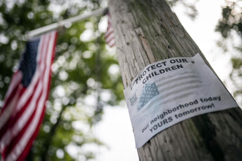 Protest signs are posted outside the former Saint John Villa Academy being repurposed as a shelter for homeless migrants, Wednesday, Sept. 13, 2023, in the Staten Island borough of New York. Scott Herkert, a New Yorker upset that the city has been housing homeless migrants on his suburban block, has set up a loudspeaker to deliver an unwelcoming message in six languages to his new neighbors: "The community wants you to go back to New York City. Immigrants are not safe here." (AP Photo/John Minchillo)