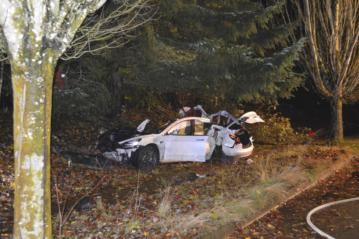 The scene where an Oregon man crashed a Tesla while going about 100 mph, destroying the vehicle, a power pole and starting a fire when some of the hundreds of batteries from the vehicle broke windows and landed in residences in Corvallis, Ore., in November 2020. (Corvallis Police Dept. via AP)