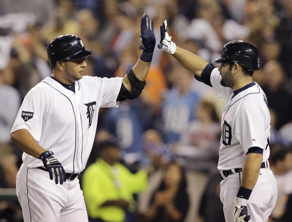 Detroit Tigers' Jhonny Peralta, left, is greeted by teammate Alex Avila after a solo home run during the sixth inning of Game 3 of baseball's American League championship series against the Texas Rangers, Tuesday, Oct. 11, 2011, in Detroit. (AP Photo/Paul Sancya)